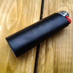 Refillable lighter with black leather sleeve